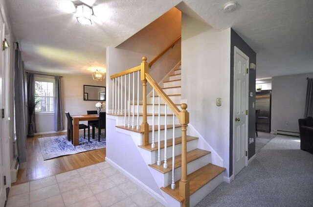 3 Cornet Stetson, Rockland, MA 02370 - staircase featuring baseboard heating, baseboards, tile patterned flooring, and a chandelier
