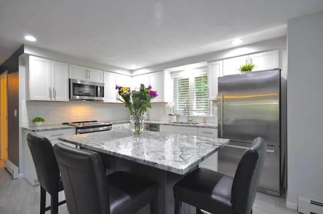 3 Cornet Stetson, Rockland, MA 02370 - kitchen featuring stainless steel appliances, baseboard heating, a sink, a breakfast bar area, and recessed lighting