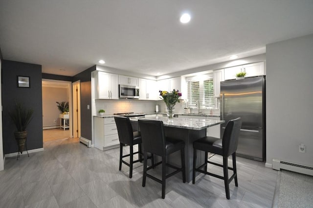 3 Cornet Stetson, Rockland, MA 02370 - kitchen featuring appliances with stainless steel finishes, baseboard heating, white cabinetry, a breakfast bar, and recessed lighting