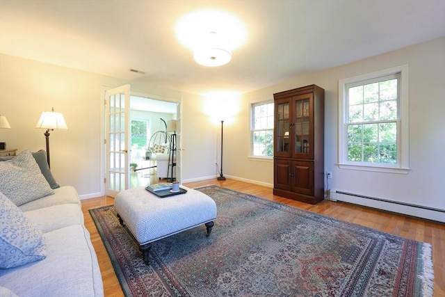 2 David Henry Gardner Ln, Southborough, MA 01772 - living area with baseboard heating, wood finished floors, and baseboards