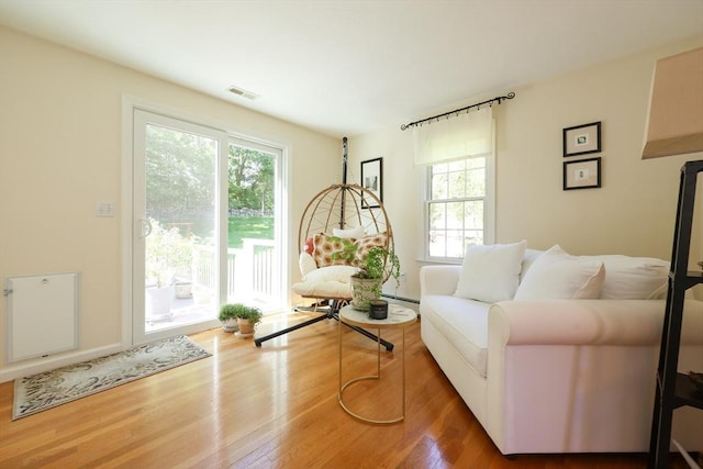 2 David Henry Gardner Ln, Southborough, MA 01772 - living area featuring plenty of natural light, wood finished floors, and baseboard heating