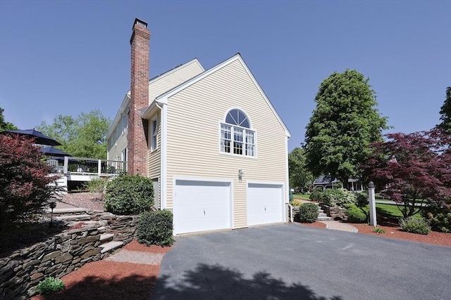 2 David Henry Gardner Ln, Southborough, MA 01772 - view of side of property featuring a garage, driveway, and a chimney