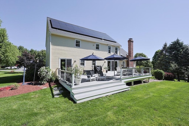 2 David Henry Gardner Ln, Southborough, MA 01772 - back of house featuring solar panels, a chimney, a yard, and a wooden deck