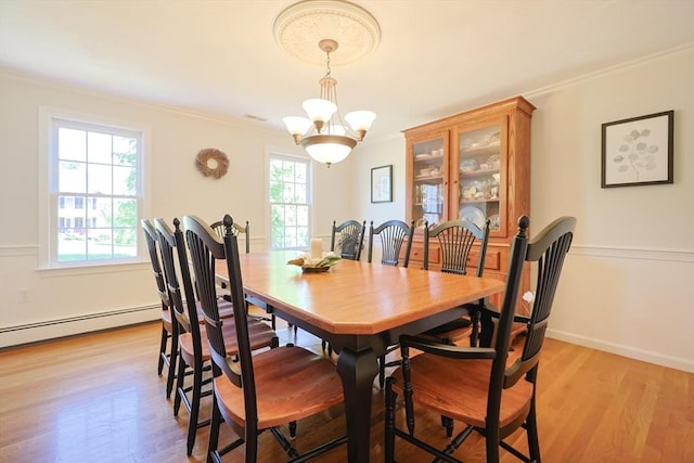 2 David Henry Gardner Ln, Southborough, MA 01772 - dining area featuring crown molding, a baseboard heating unit, light wood-type flooring, a chandelier, and baseboards
