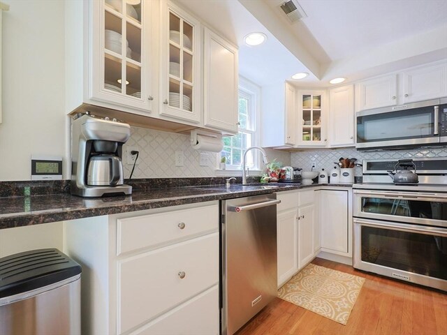 2 David Henry Gardner Ln, Southborough, MA 01772 - kitchen with stainless steel appliances, white cabinets, light wood finished floors, recessed lighting, and tasteful backsplash