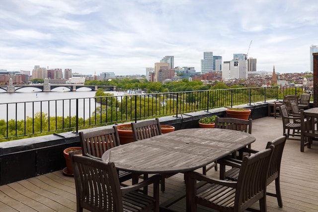 172 Beacon St Unit 4, Boston, MA 02116 - wooden deck featuring a view of city, outdoor dining area, and a water view