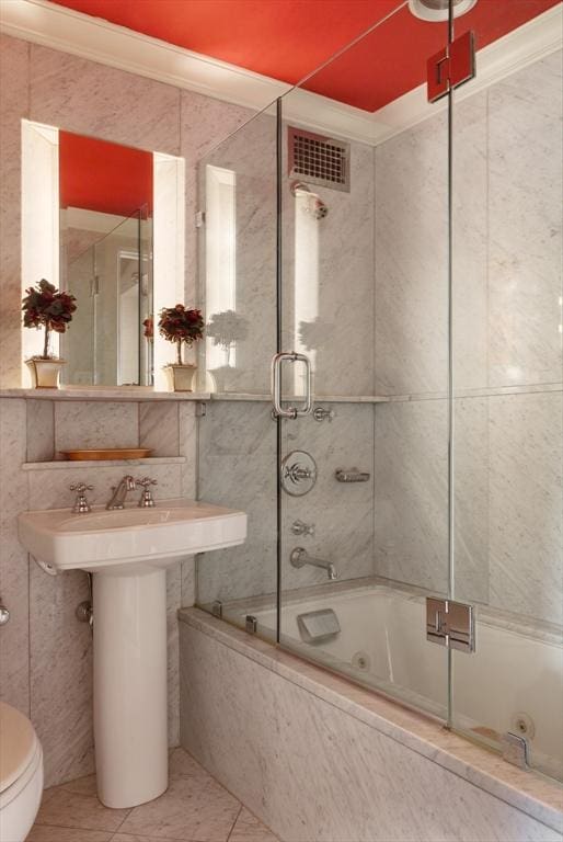 172 Beacon St Unit 4, Boston, MA 02116 - full bath featuring toilet, tile patterned flooring, shower / bath combination with glass door, tile walls, and a sink