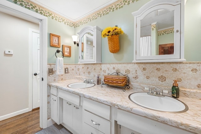 bathroom with crown molding, hardwood / wood-style floors, and vanity