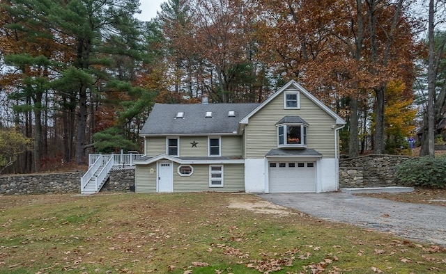 front of property with a garage and a front lawn