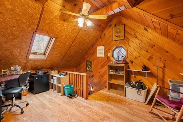 office space featuring light hardwood / wood-style floors, a wealth of natural light, wooden walls, and ceiling fan