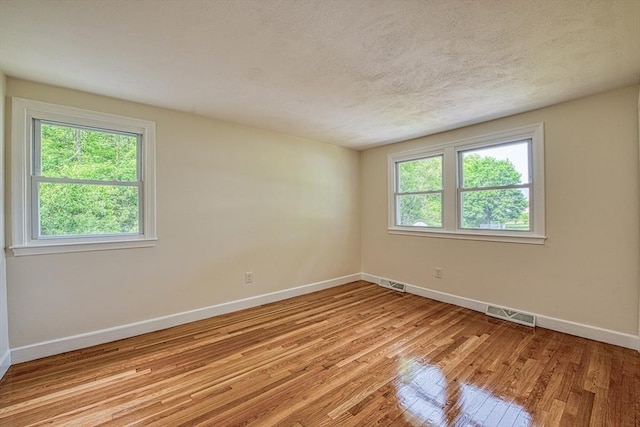 143 Ryan Rd, Stoughton, MA 02072 - empty room with baseboards, light wood-style floors, and a textured ceiling
