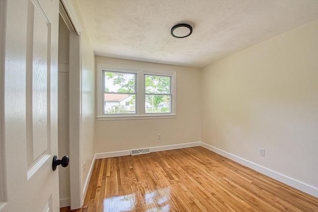 143 Ryan Rd, Stoughton, MA 02072 - unfurnished room featuring light wood-style floors, baseboards, and a textured ceiling