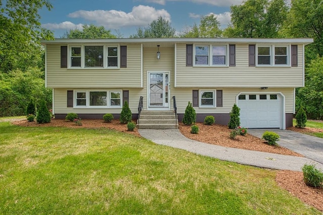 143 Ryan Rd, Stoughton, MA 02072 - split foyer home featuring asphalt driveway, a garage, and a front lawn