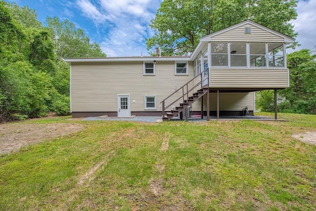 143 Ryan Rd, Stoughton, MA 02072 - back of property featuring a sunroom, a lawn, and stairway