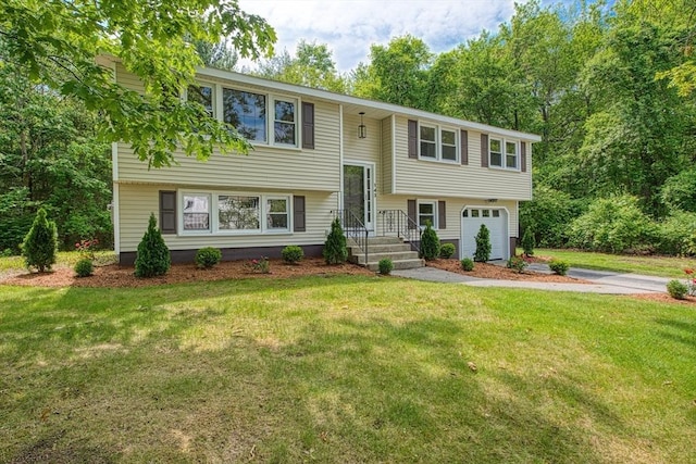 143 Ryan Rd, Stoughton, MA 02072 - split foyer home with an attached garage, driveway, and a front lawn