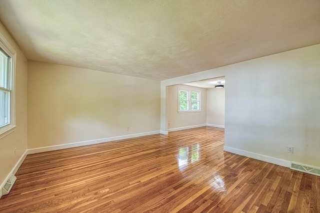 143 Ryan Rd, Stoughton, MA 02072 - spare room featuring light wood-type flooring, baseboards, and a textured ceiling
