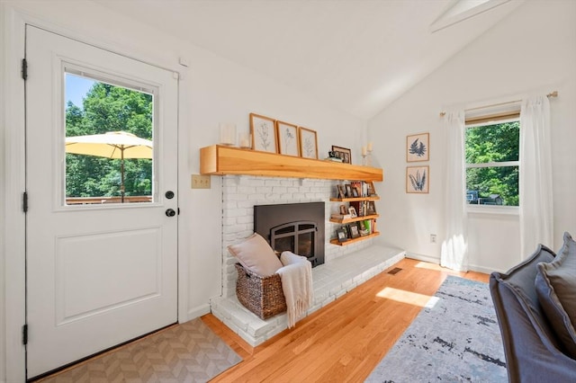965 Main St, Wilbraham, MA 01095 - living area with plenty of natural light, wood finished floors, lofted ceiling, and a brick fireplace