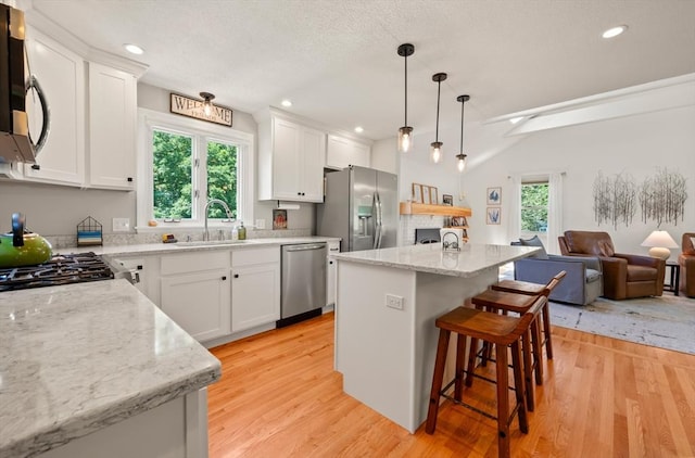 965 Main St, Wilbraham, MA 01095 - kitchen with appliances with stainless steel finishes, open floor plan, light wood finished floors, a kitchen bar, and recessed lighting