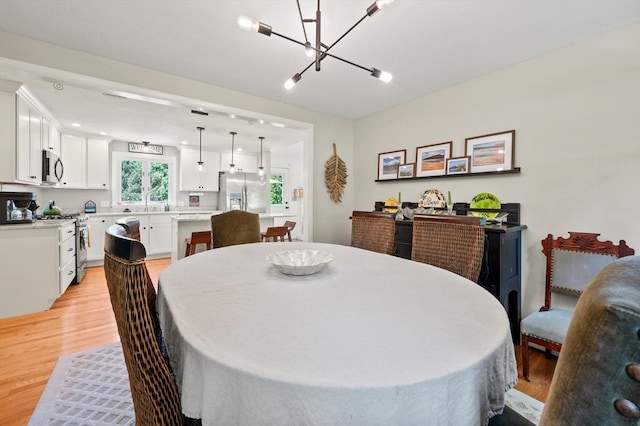 965 Main St, Wilbraham, MA 01095 - dining space featuring light wood-style flooring and a chandelier