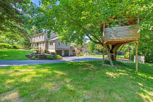 965 Main St, Wilbraham, MA 01095 - view of green lawn featuring stairs, a garage, and driveway