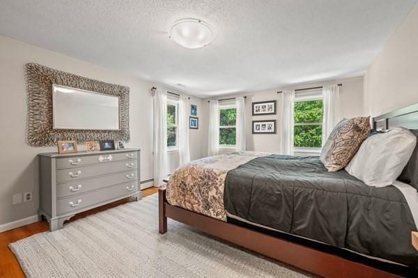 965 Main St, Wilbraham, MA 01095 - bedroom featuring wood finished floors and a textured ceiling