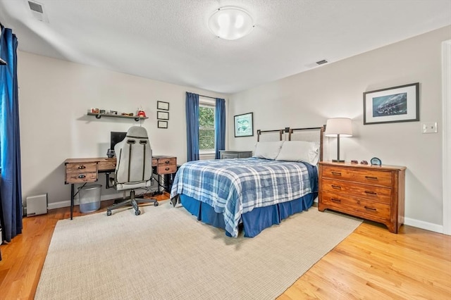 965 Main St, Wilbraham, MA 01095 - bedroom featuring wood finished floors, a textured ceiling, and an office area