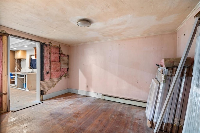 11 Williams St, Dudley, MA 01571 - spare room featuring baseboard heating, hardwood / wood-style floors, and baseboards