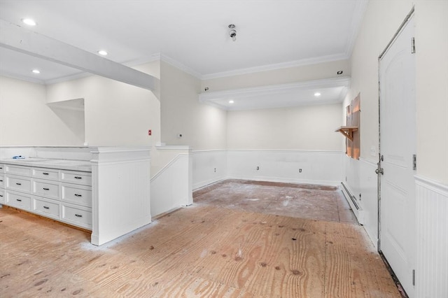 11 Williams St, Dudley, MA 01571 - empty room with baseboard heating, a wainscoted wall, ornamental molding, light wood-style flooring, and recessed lighting