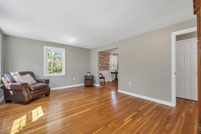 living area with baseboards and light wood-style floors