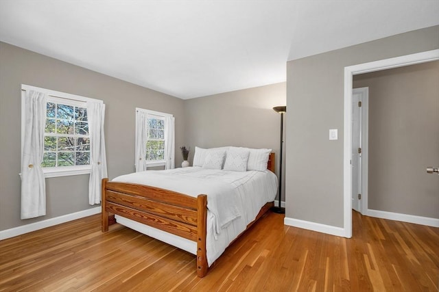 bedroom with baseboards and light wood-type flooring