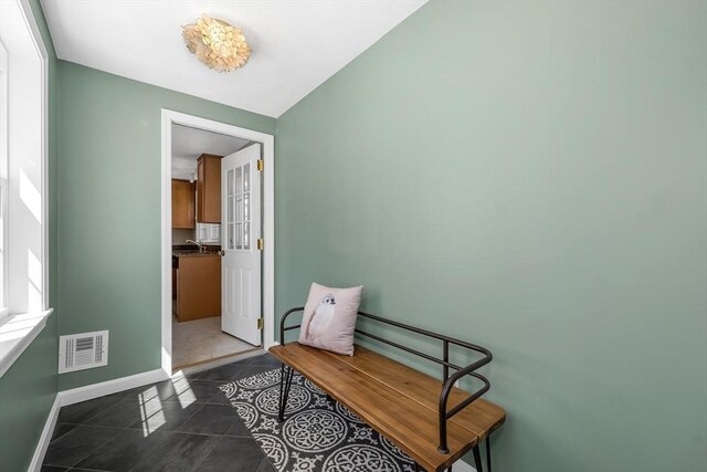 interior space with baseboards and visible vents