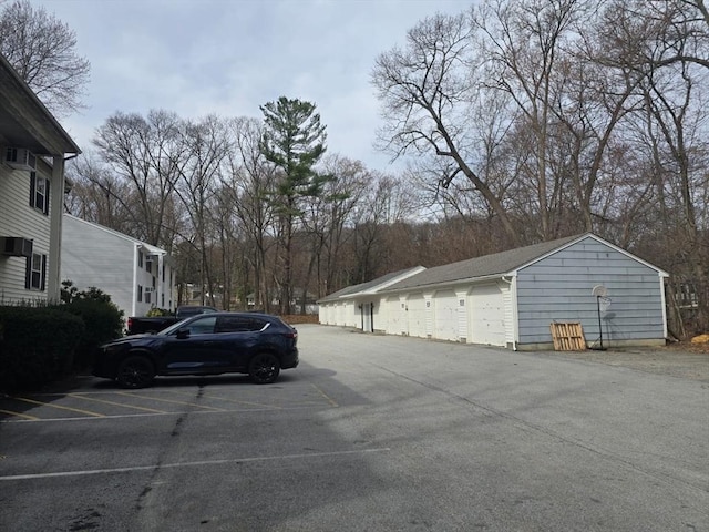 view of parking / parking lot with community garages
