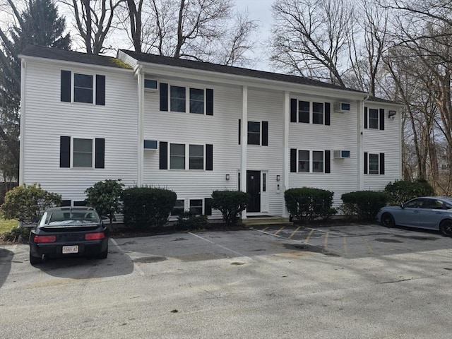 view of property featuring uncovered parking