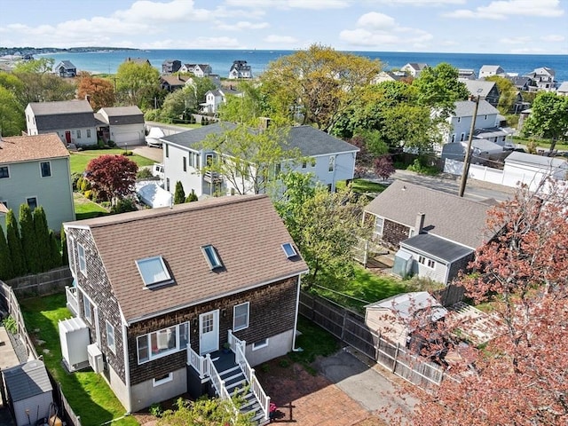 aerial perspective of suburban area with a large body of water
