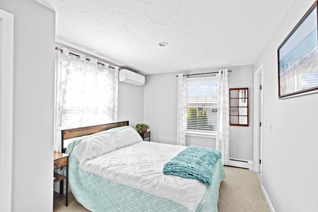 carpeted bedroom with an AC wall unit, baseboard heating, a textured ceiling, and baseboards