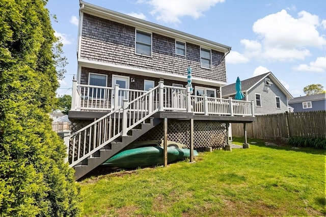 rear view of property featuring a wooden deck and stairway