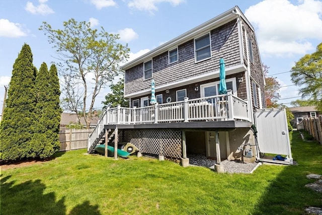 rear view of property featuring a wooden deck and stairs