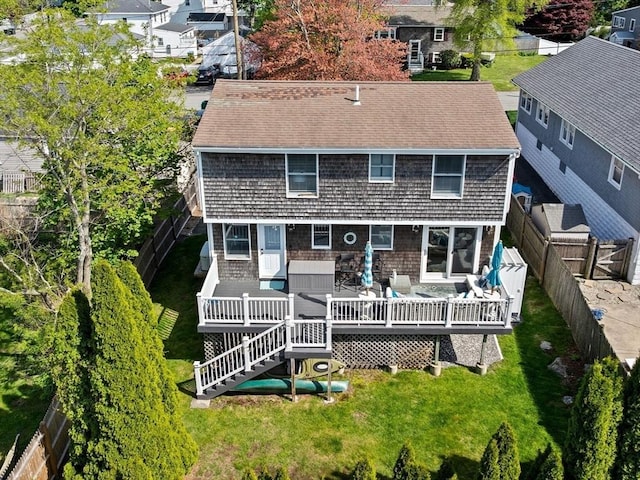 rear view of house featuring a wooden deck, a residential view, and roof with shingles