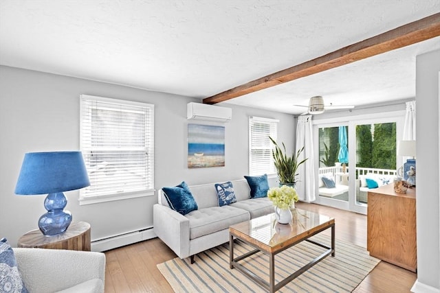 living room with a baseboard heating unit, beamed ceiling, a wall mounted AC, light wood-type flooring, and a textured ceiling