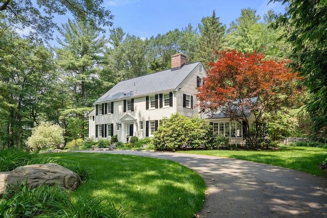 117 Deer Path Ln, Weston, MA 02493 - colonial-style house featuring a chimney and a front lawn