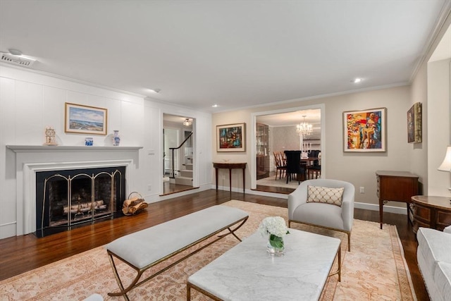 117 Deer Path Ln, Weston, MA 02493 - living room with stairs, wood finished floors, ornamental molding, a fireplace with flush hearth, and a chandelier