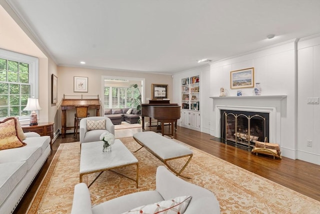 117 Deer Path Ln, Weston, MA 02493 - living area featuring wood finished floors, healthy amount of natural light, built in shelves, ornamental molding, and recessed lighting