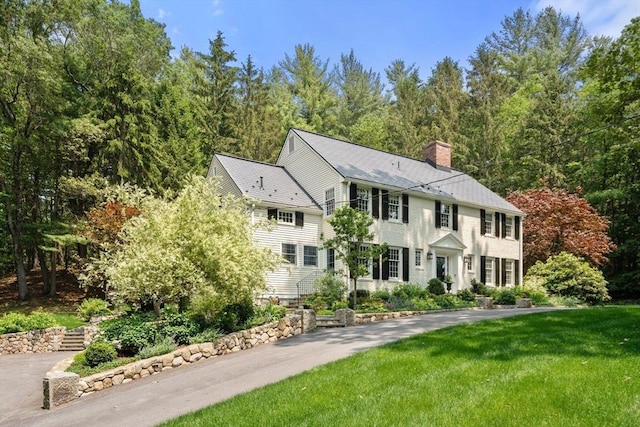 117 Deer Path Ln, Weston, MA 02493 - colonial-style house featuring a chimney and a front yard