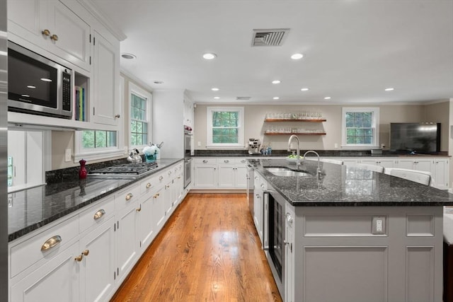 117 Deer Path Ln, Weston, MA 02493 - kitchen featuring appliances with stainless steel finishes, an island with sink, dark stone counters, white cabinetry, and recessed lighting