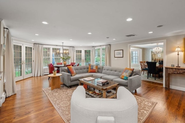 117 Deer Path Ln, Weston, MA 02493 - living area featuring a chandelier, ornamental molding, healthy amount of natural light, french doors, and light wood-style floors