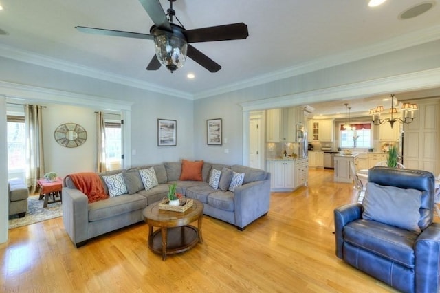 living room with crown molding, recessed lighting, ceiling fan, and light wood-style floors