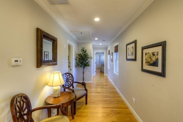 hall featuring ornamental molding, baseboards, attic access, recessed lighting, and light wood finished floors