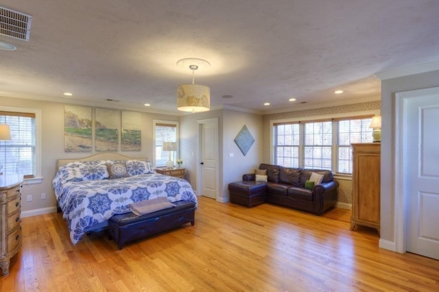 bedroom featuring crown molding, multiple windows, and visible vents