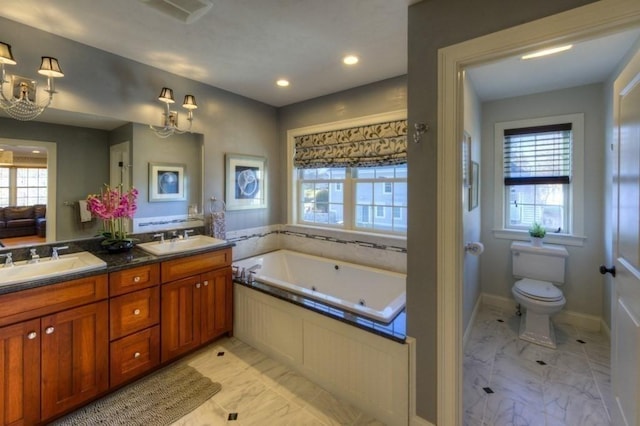full bath with toilet, plenty of natural light, a sink, and marble finish floor
