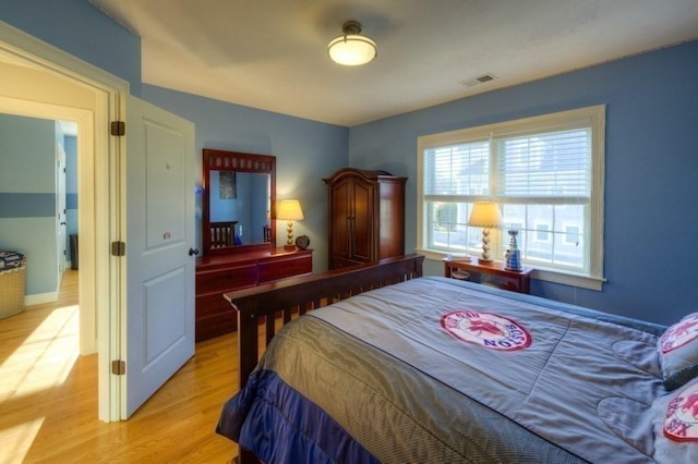 bedroom featuring light wood-style flooring and visible vents